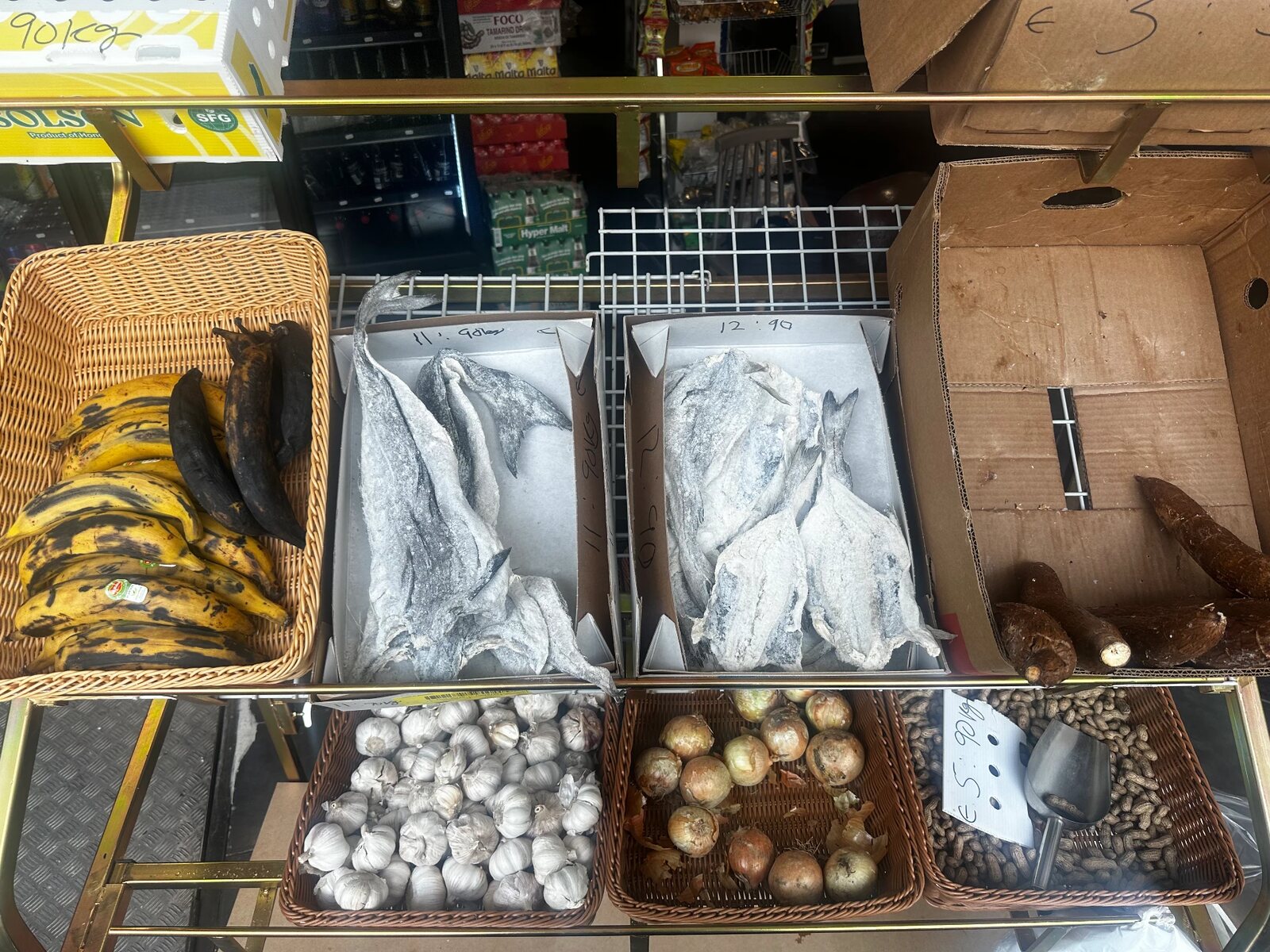 Plantains, yams, onions, garlic, and dried fish at TEGA AFRO STORE